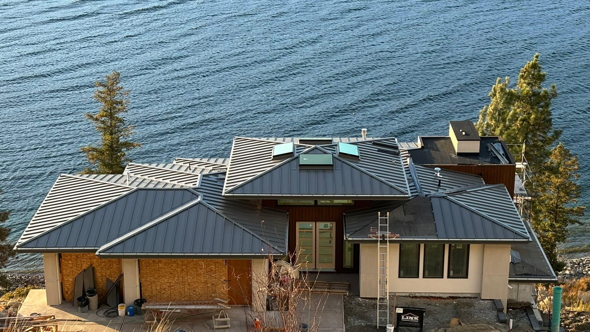 Charcoal standing seam metal roof on a lakefront home in the Okanagan