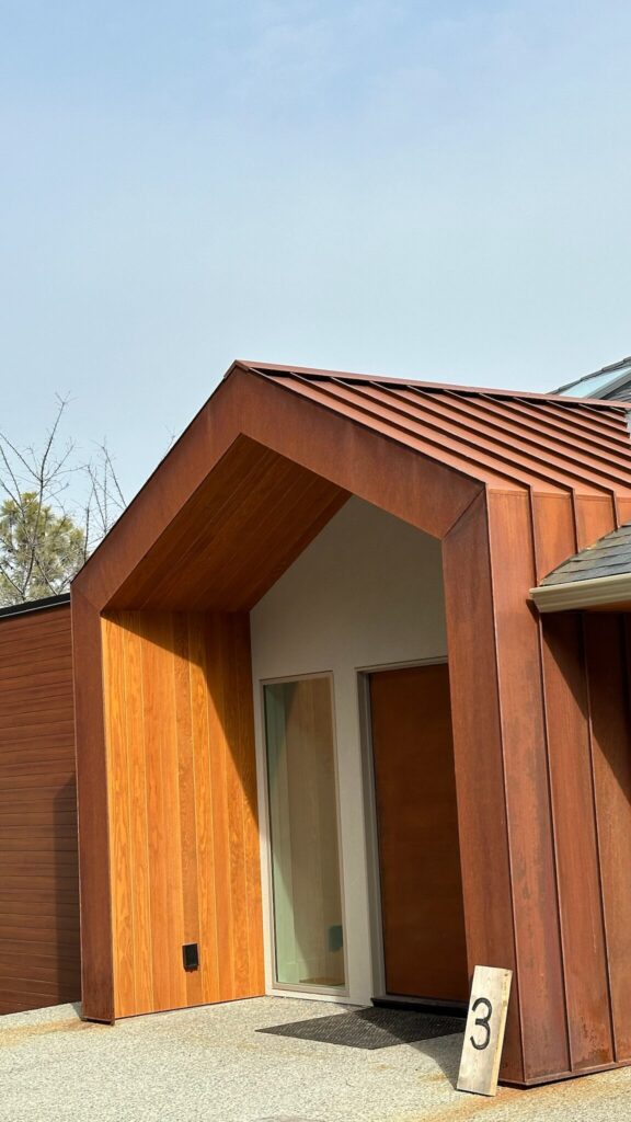 Corten steel entryway with standing seam cladding and a cedar soffit on a modern Okanagan home